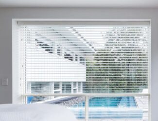 White Venetian Blinds In A Bedroom